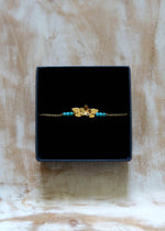 bracelet petite fleur dorée et perles en turquoise. Bijou fin et léger fabriqué en France