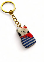 Porte-clé Lucky Rolie Cat Gwendal — petit chat tricolore breton en marinière bleu marine, modelé et peint à la main en argile, fini à la résine UV. Pièce unique fait main en Bretagne.